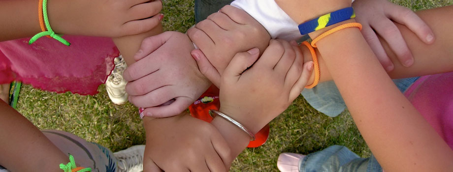 Children holding arms